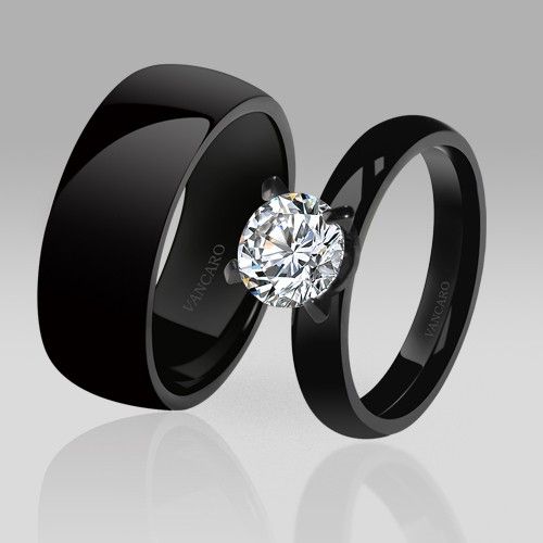 two black wedding bands with a diamond in the center and an engagement ring on each side