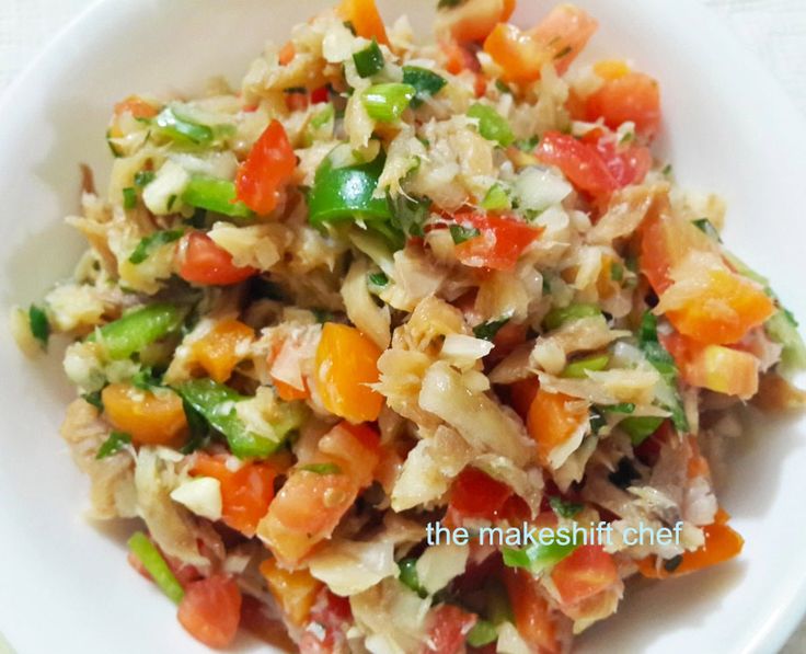 a white bowl filled with rice and vegetables