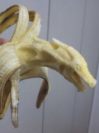 a peeled banana being held up to the camera