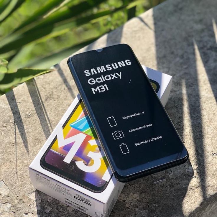 the samsung galaxy m11 is next to an unopened box