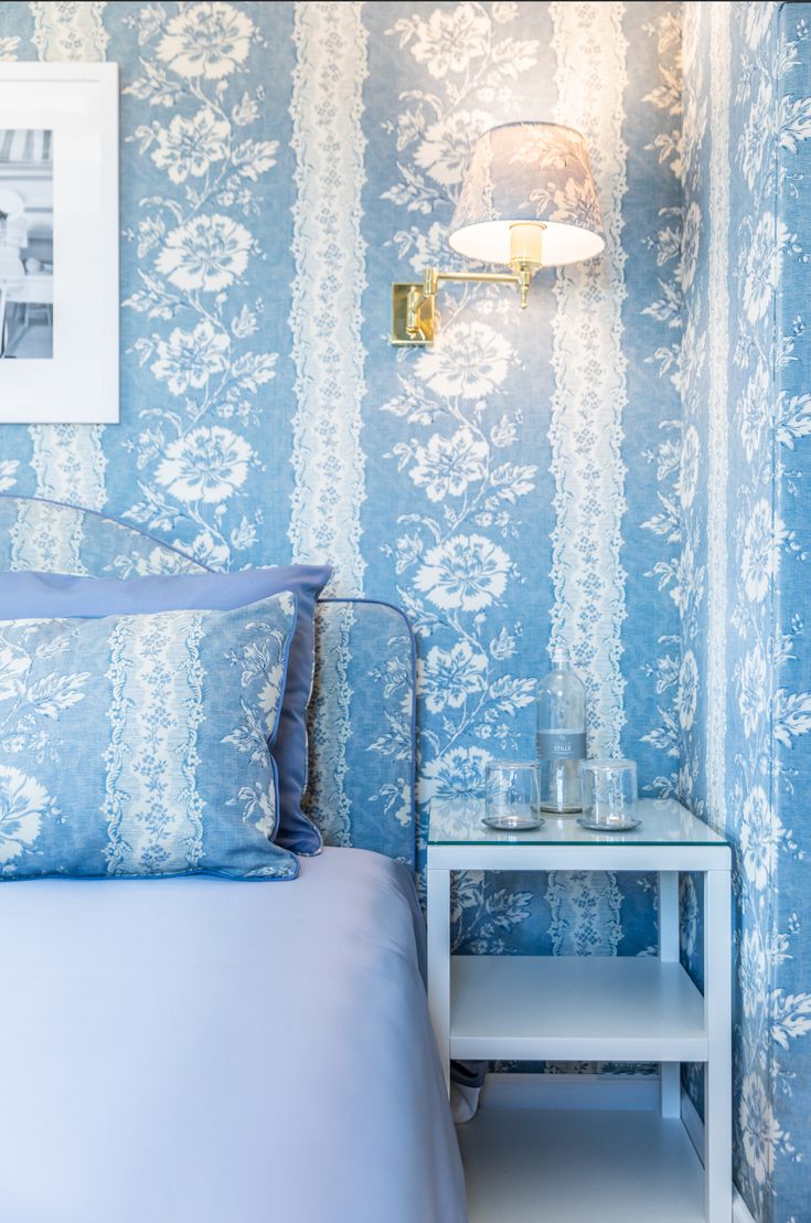 a bedroom with blue and white wall paper