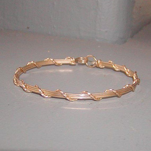 A pretty little bracelet of four strands of 14kt gold filled--three plain square wires, overwrapped with one strand of twist wire. Charming and feminine, and perfect to wear every day. Stackable with so many of my other wirewrapped bracelets! What a sweet graduation gift for a special young lady! Or just as nice for a birthday, Christmas, or Hanukkah. Of course, you can always treat yourself as well! The sturdy built-in hook and eye clasp is easy to get on and off by yourself. Choose your size f Gold Wire Wrapped 14k Gold-filled Bracelets, Gold Wire Wrapped Bracelets In 14k Gold Filled, Wire Wrapped 14k Gold Filled Bracelets, Dainty Hand Wrapped Gold Bracelet, Gold Wire Wrapped Bracelets, Gold Wire Wrapped Wrap Bracelet As A Gift, Wire Wrapped Jewelry Diy, Teen Jewelry, Diy Bracelets Easy