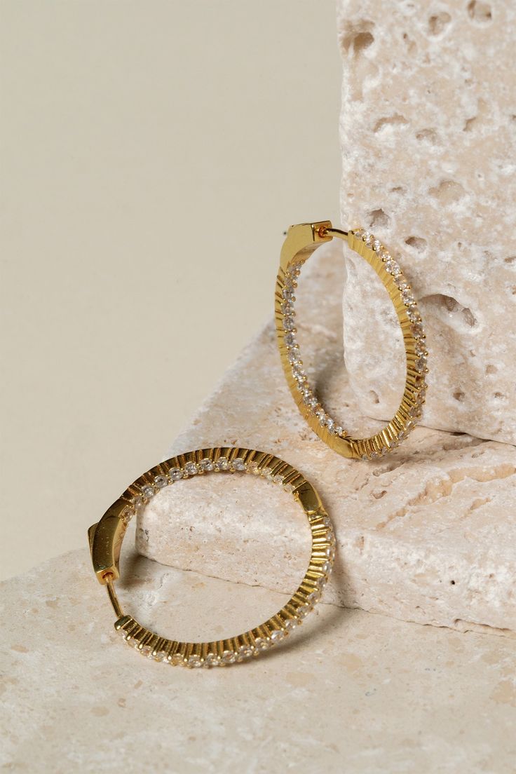 Showcase the brilliance of pavé stones with our Eliza Pavé Hoop Earrings, designed to mix and match with our pavé and metal earrings. Part of our Stackable Jewelry assortment. Hoop earrings with claw-set pavé stones, hinged closure. Gold: 18K gold plated brass. Silver: rhodium plated brass. Nickel- and lead-free. Avoid water, soap, and harsh chemicals. Store in a box or bag in a cool, dry place. Clean using a dry soft cloth. Hoop Earrings With Pave Setting In Cubic Zirconia, Cubic Zirconia Hoop Earrings With Pave Setting, Sparkling Stones Hoop Earrings, Modern Hoop Jewelry With Pave Setting, Modern Gold Hoop Earrings With Pave Setting, Gold Metal Hoop Earrings With Sparkling Stones, Everyday Hoop Earrings With Sparkling Stones, Gold Hoop Jewelry With Sparkling Stones, Hoop Diamond Earrings With Pave Setting