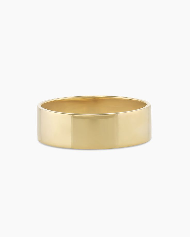 a gold wedding ring on a white background