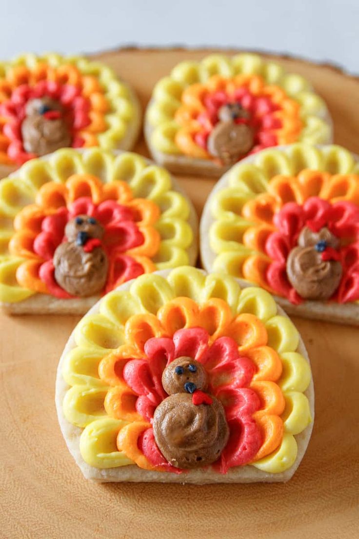 cookies decorated with icing and colored turkeys on a wooden platter, ready to be eaten