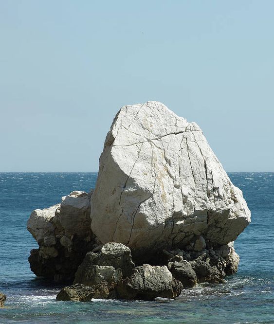 a large rock sticking out of the ocean