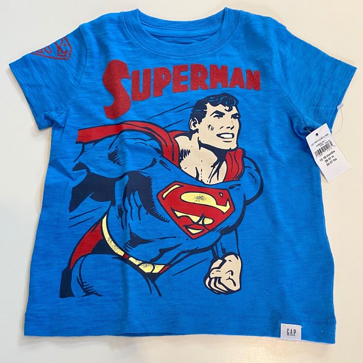 New With Tags. Special Edition Baby Gap Dc Superman Tshirt, Size 12-18 Months Gap Graphic Tee With Character Print, Blue Superhero T-shirt With Character Print, Gap Short Sleeve T-shirt With Character Print, Gap Cotton Tops With Logo Print, Gap Short Sleeve Pre-shrunk T-shirt, Gap Short Sleeve Tops With Letter Print, Graphic Tee Tops With Character Print For Playtime, Gap Cotton Tops With Character Print, Graphic Tee With Character Print For Playtime