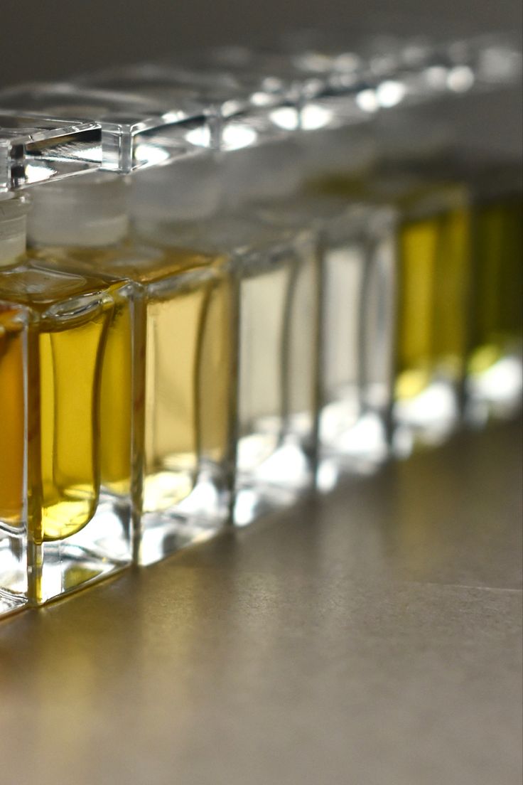 several small glass containers filled with different colored liquids