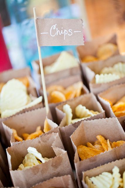 small boxes filled with chips sitting on top of a table next to a sign that says chips