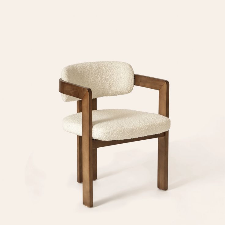 a wooden chair with a white upholstered seat and backrest, on a plain background