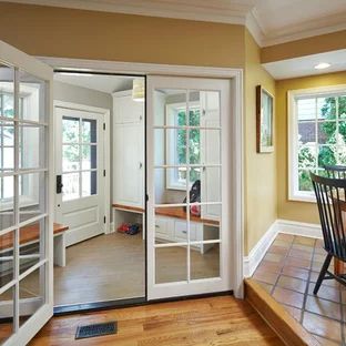 an empty dining room with french doors leading into the kitchen