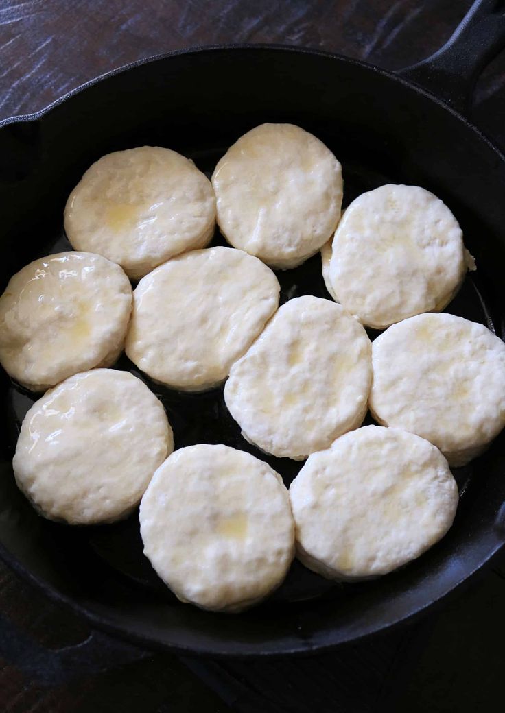 some biscuits are cooking in a skillet on the table