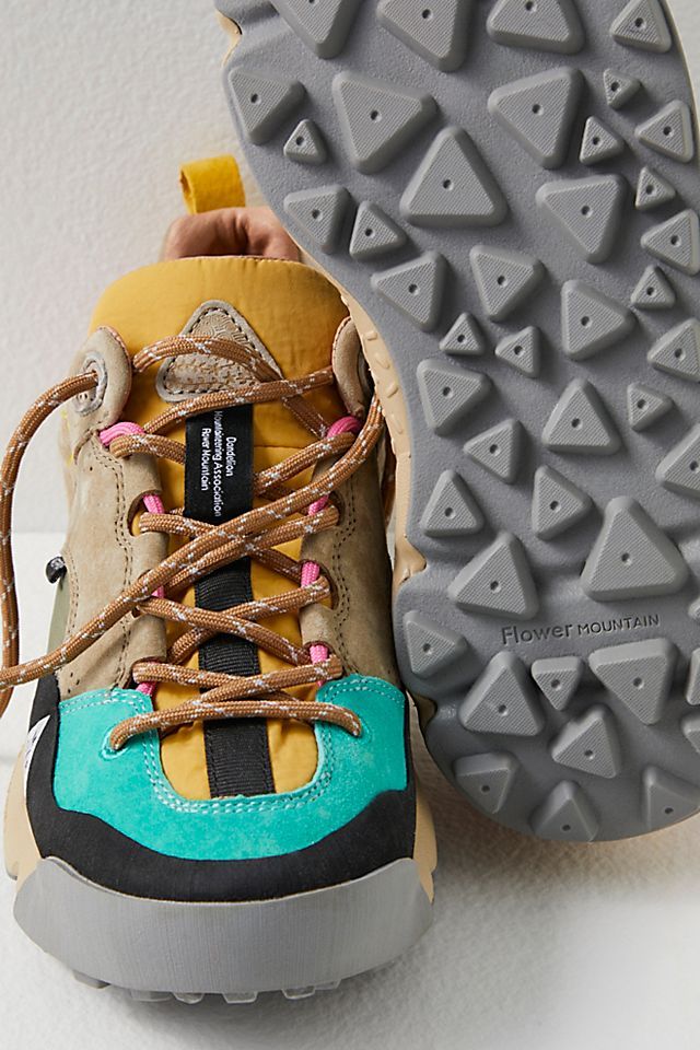 a pair of hiking shoes with laces on the outstretches are shown