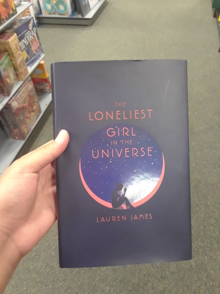 the lonelist girl in the universe by lauren james is shown holding up a book