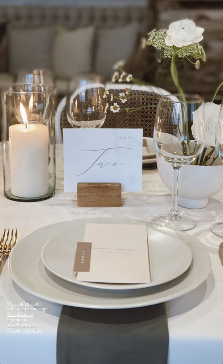 a table set with place settings and candles