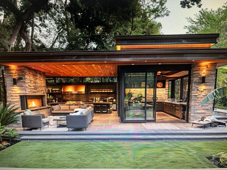 an outdoor living area with couches, tables and fire pit in the middle of it