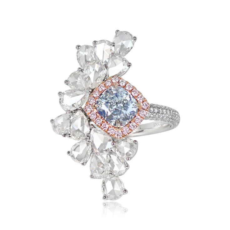 This ring features a 1.18 carat GIA-certified cushion cut Fancy Very Light Blue diamond, set in prongs and surrounded by a halo of round fancy pink diamonds. The fancy pink diamonds weigh 0.16 carats in total. An asymmetrical design of pear shape rose cut diamonds is set accenting the center stone, with a total diamond weight of 0.35 carats. Diamond-studded shoulders featuring multiple rows of micro-pave round brilliants lead past a geometric under-gallery decorated with additional round brilliant diamonds. The total weight of the round brilliant cuts is 0.55 carats. This ring is 18k rose gold on 18k white gold.

A copy of the GIA certificate for the center stone is available upon request.

The measurements of this ring are approximately 2.7cm x 1.6cm.

This ring can be resized to any fing Light Blue Diamond, Fancy Color Diamond Ring, Vintage Diamond Earrings, Asscher Cut Ring, Kunzite Ring, Fancy Diamond Ring, Estate Diamond Jewelry, Glamorous Jewelry, Gia Certificate