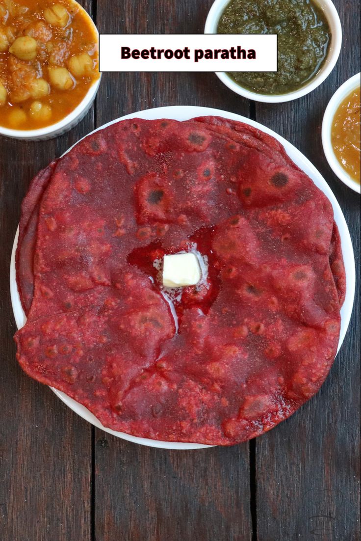 there are three different types of food on the table, one is beetroot paratha