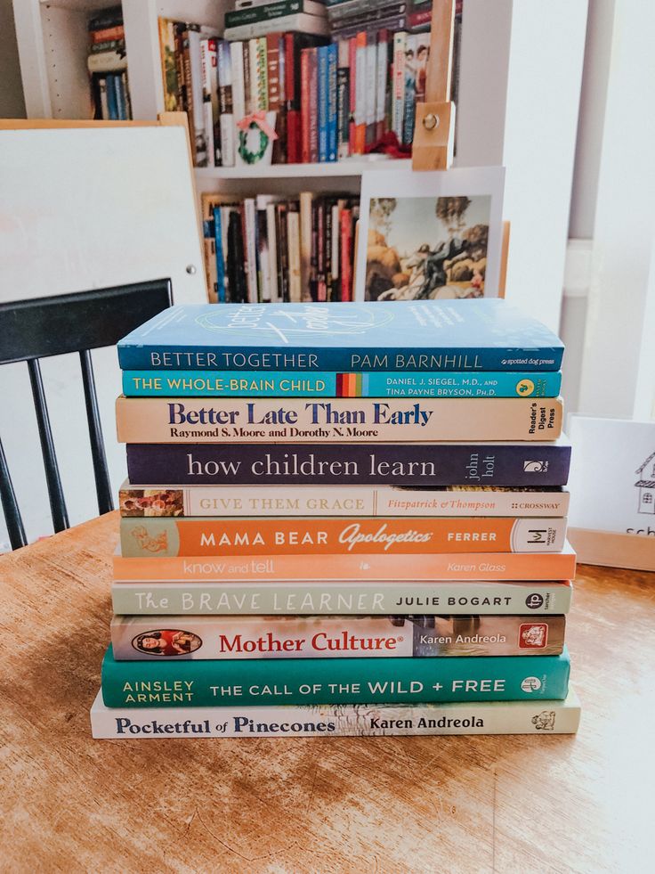 a stack of books sitting on top of a wooden table