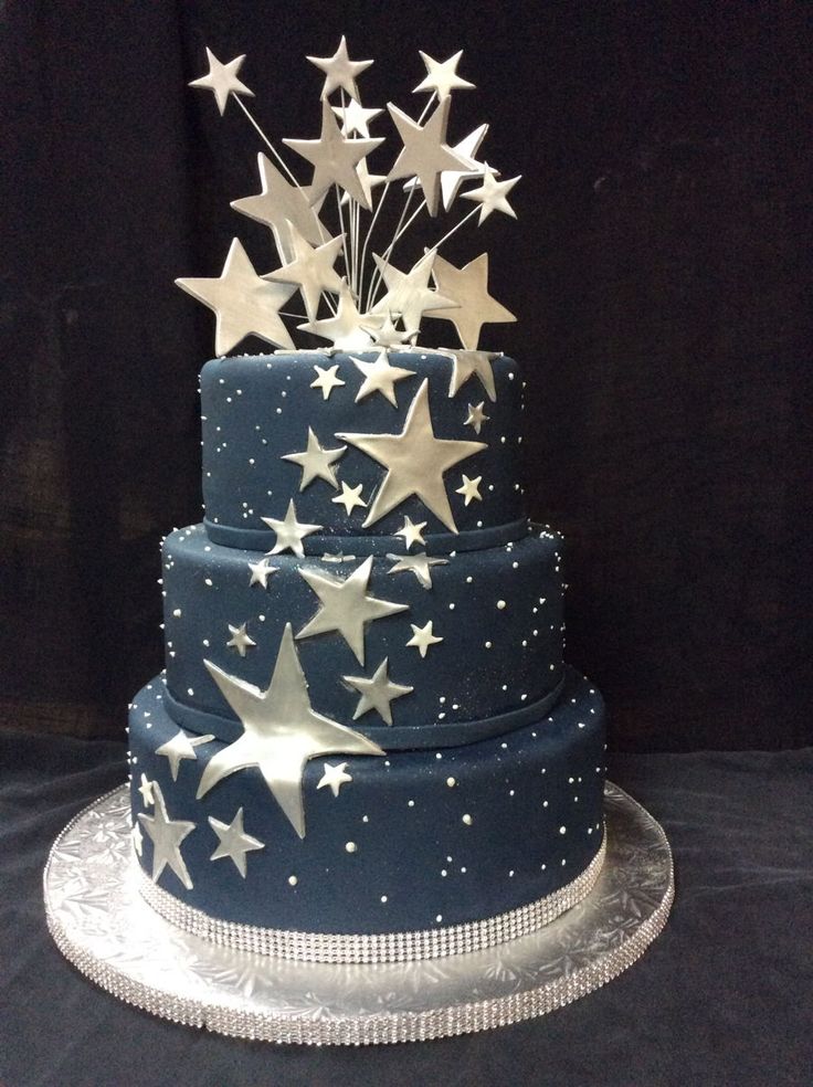 a three tiered cake with stars on it's side and blue icing