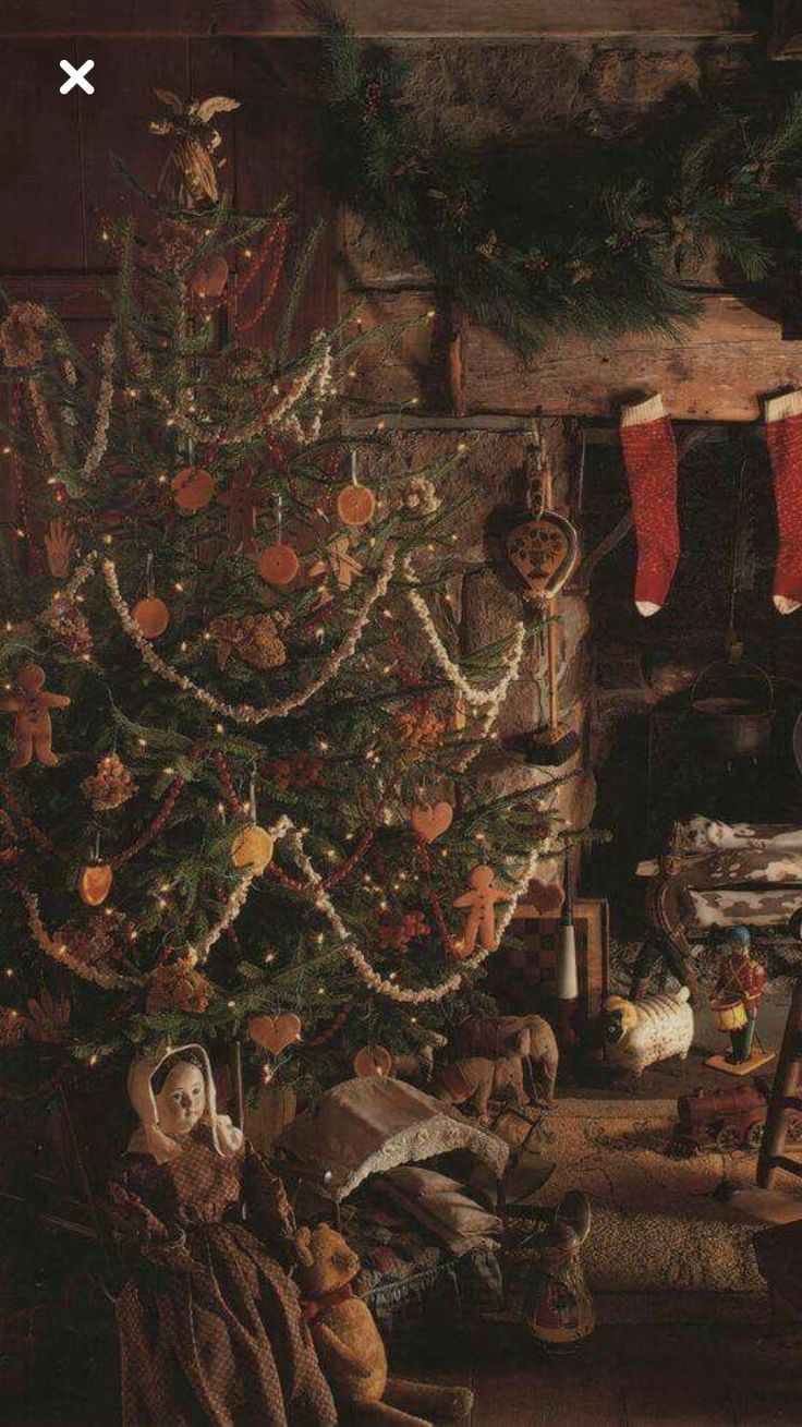 a christmas tree with stockings hanging from it's sides in front of a fireplace