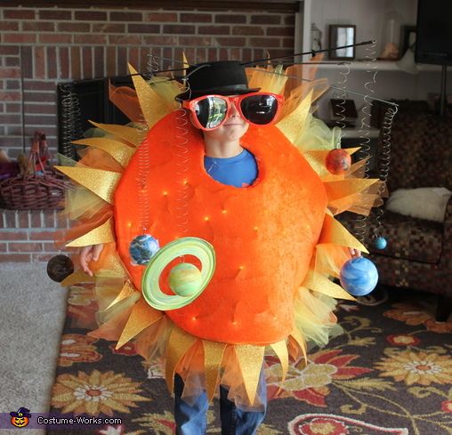 a man dressed in an orange costume and sunglasses