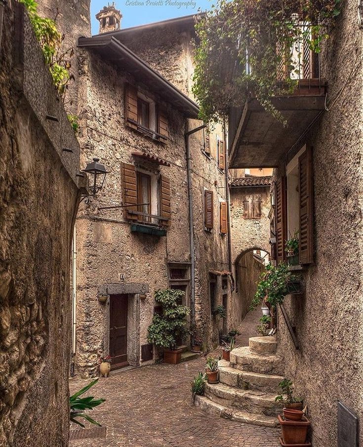 the instagram page on instagram shows an alleyway with stone buildings and plants