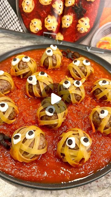 a pizza with googly eyes on it sitting on top of a table next to other food items