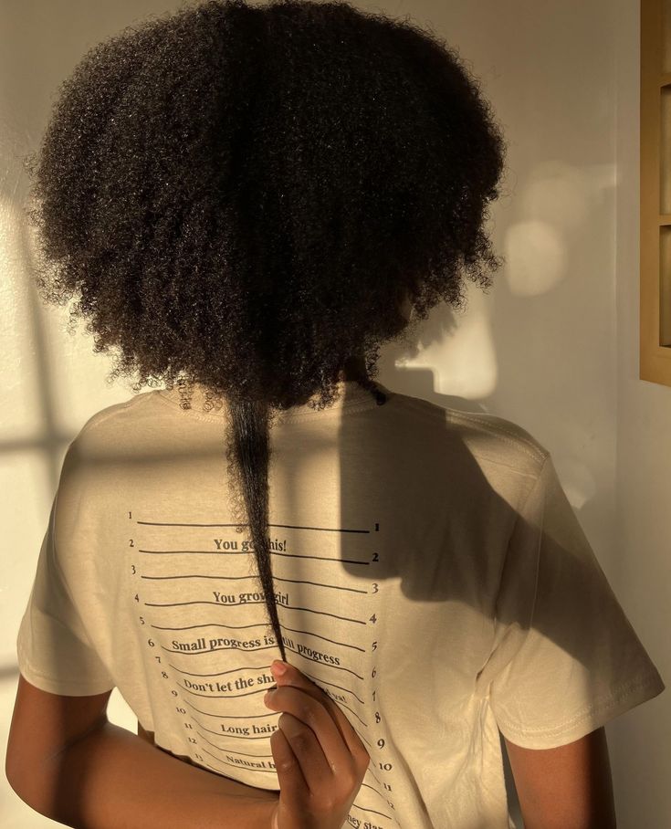 Ready to see your hair growth journey in action?⁠ Our length check t-shirt is the perfect tool to track your progress and celebrate every inch!💁🏽‍♀️✨️⁠ ⁠ 📸:@_.ke.ndiii⁠ ⁠ Shop via our website: www.organicbeautyusa.com🛍️⁠ .⁠ .⁠ .⁠ #naturalhairjourney #hairgrowth #hairgoals #lengthcheck #lengthchecktshirt #organicbeautyessence Afro Hair Growth, Hair Growth Progress, 4c Hair Growth, Hair Growth Journey, 4b Hair, 4a Hair, Length Check, Beauty Essence, Type 4 Hair