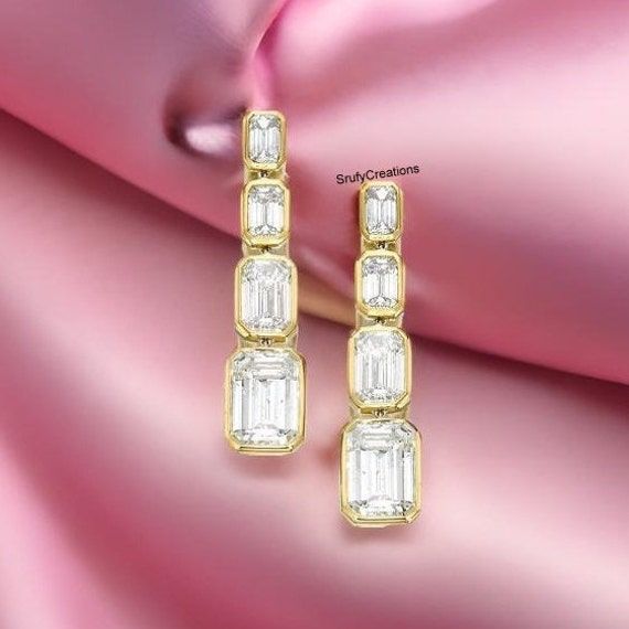 18.5 TCW Emerald Cut Liner Drop Wedding Earrings, 4 Diamond Bezel Set Screw Back Earrings, 14k Yellow Gold Engagement Earrings, Gift For Her Detail about stones Moissanite & Simulated Stone: ----------------------------- Stone Shape : Emerald Cut Stone Size : 10X8 mm, 9X6 mm, 8X6 mm, 7X5 mm Weight: 18.50 TCW Color: Colorless Cut: Excellent Clarity: VVS ✎ This is all our photography. This listing's image is only reference image. If you give me order then I will make this jewelry looks like listing's image ✿ Place your custom order here ☛ handmade moissanite made with festinating and brilliance. Stone is produced with excellent cuts, grades and superior quality. ☛ Metal Option: Silver/10KT/14KT/18KT ☛ Metal Tones: Yellow Gold, White Gold, Rose Gold   ✿ Stone type options: ☛ Natural Diamond, Gold Linear Earrings With Prong Setting For Wedding, Gold Linear Anniversary Earrings With Prong Setting, Gold Linear Earrings With Prong Setting For Anniversary, Gold Baguette Cut Earrings For Wedding, Yellow Gold Diamond Linear Earrings For Wedding, Formal Gold Bezel Set Earrings, Gold Baguette Cut Earrings For Anniversary, Wedding Diamond Earrings 14k Gold Baguette Cut, Wedding 14k Gold Baguette Cut Diamond Earrings