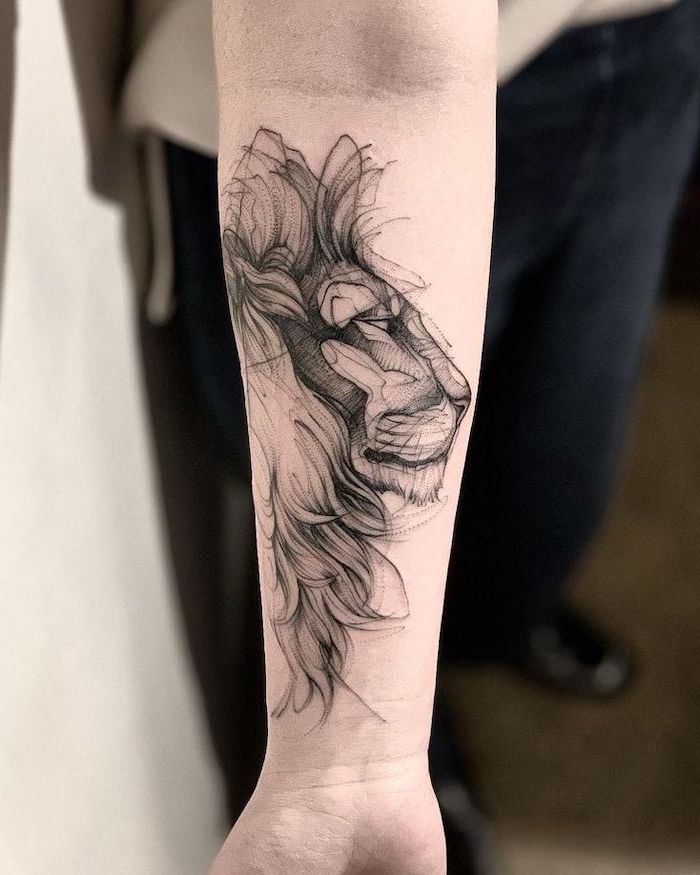 a lion tattoo on the left arm and wrist is shown in black ink with a white background