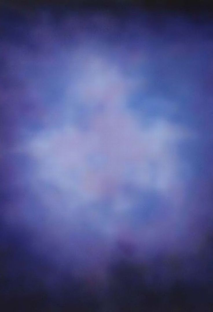 an airplane flying in the sky on a cloudy day with blue and purple clouds behind it