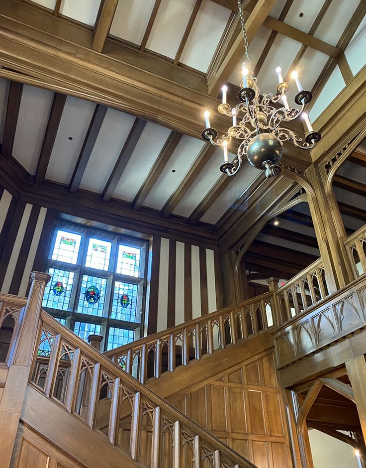 a chandelier hanging from the ceiling in a large room