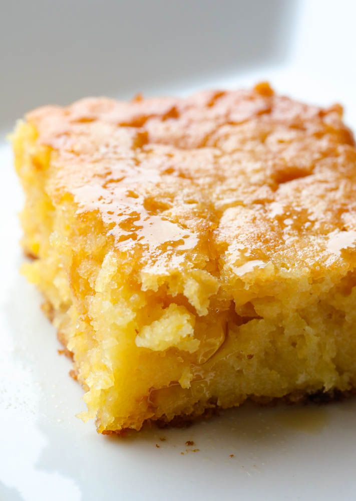 a close up of a piece of cake on a plate with some powdered sugar