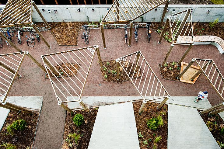 an aerial view of several wooden structures with bicycles in them