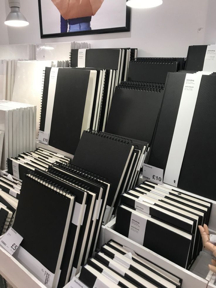 there are many black and white binders on display