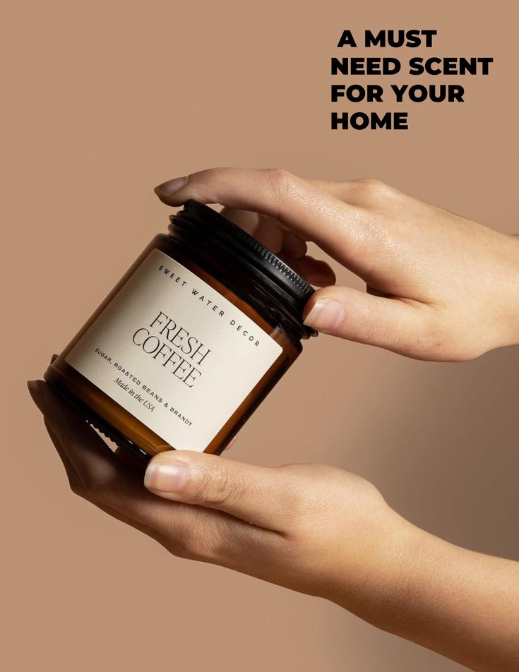 a woman holding a jar of fresh coffel in her hand with the words, a must need scent for your home