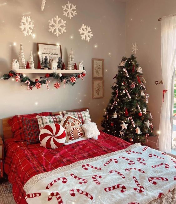 a bedroom decorated for christmas with a tree and candy canes