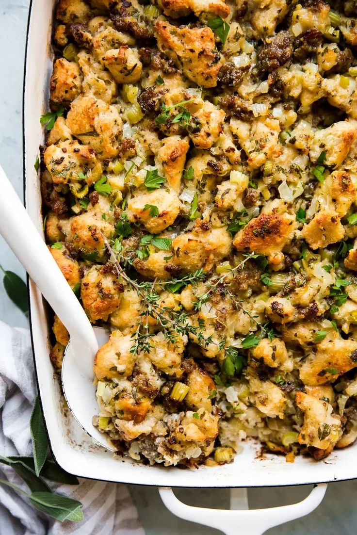 a casserole dish filled with stuffing and vegetables