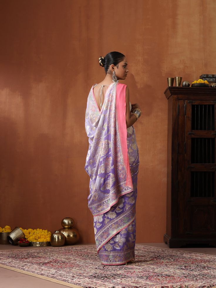 An exclusive saree from Khinkhwab. Add a dash of your favorite color to your ethnic look with this beautiful Banarasi saree from our Secret Garden collection. The Saree is made of pure Georgette and has the illustrious flower woven. Jaal weave is inherent to Banarasi weaving and this saree is the epitome of the craftsmanship of the renowned weavers of Banaras. Purple Pre-draped Saree For Puja, Traditional Purple Cotton Silk Pre-draped Saree, Designer Pre-draped Saree With Zari Weaving, Traditional Diwali Pre-draped Saree With Meenakari, Purple Cotton Silk Pre-draped Saree, Diwali Meenakari Pre-draped Saree, Chanderi Pre-draped Saree With Meenakari For Puja, Purple Cotton Silk Pre-draped Saree With Pallu, Purple Tussar Silk Saree With Meenakari