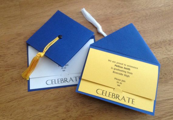 a graduation cap and tassel on top of a blue envelope with a yellow ribbon