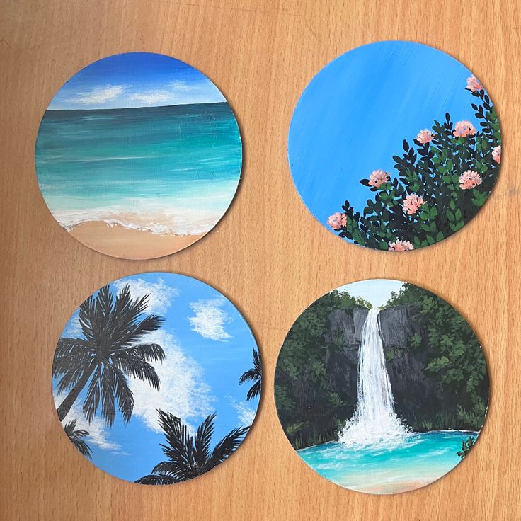 four coasters with tropical scenes painted on them