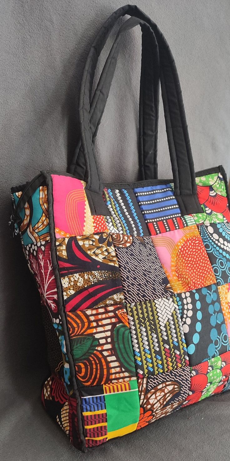 Authentic Tanzanian Africanprint shoulder bag handmade by Tanzanian Maasai Women with traditional Kitenge material 100% cotton - height: 42 Centimetres  - Length: 36.5 Centimetre - Depth: 16 Centimetre - Material: Kitenge fabric  This handbag is very fashionable, super lightweight and very spacious with an extra pocket inside.  Can carry lots of weight, perfect as working/study bag, travel bag, beach bag or casual bag. Check out our other unique African Gems on our Etsy Store VindraSAfricanGems: Study Bag, Ankara Accessories, Kitenge Fabric, Patch Bag, Ankara Bags, Kitenge, Patchwork Bags, Maasai, Bag Handmade