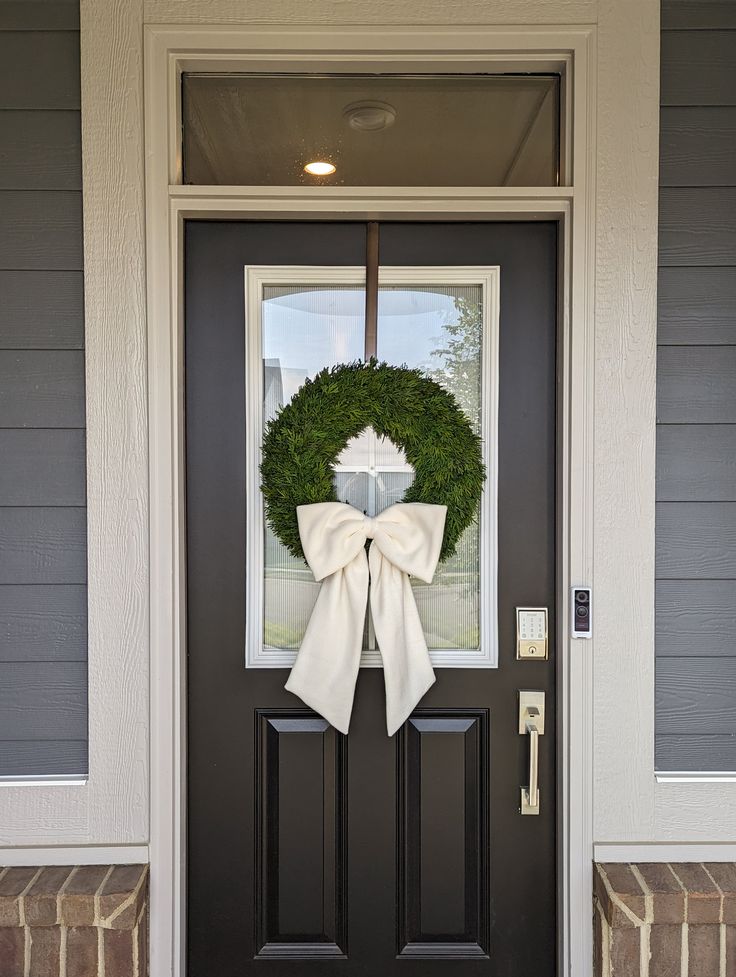 the front door is decorated with a wreath and a cross on it's side