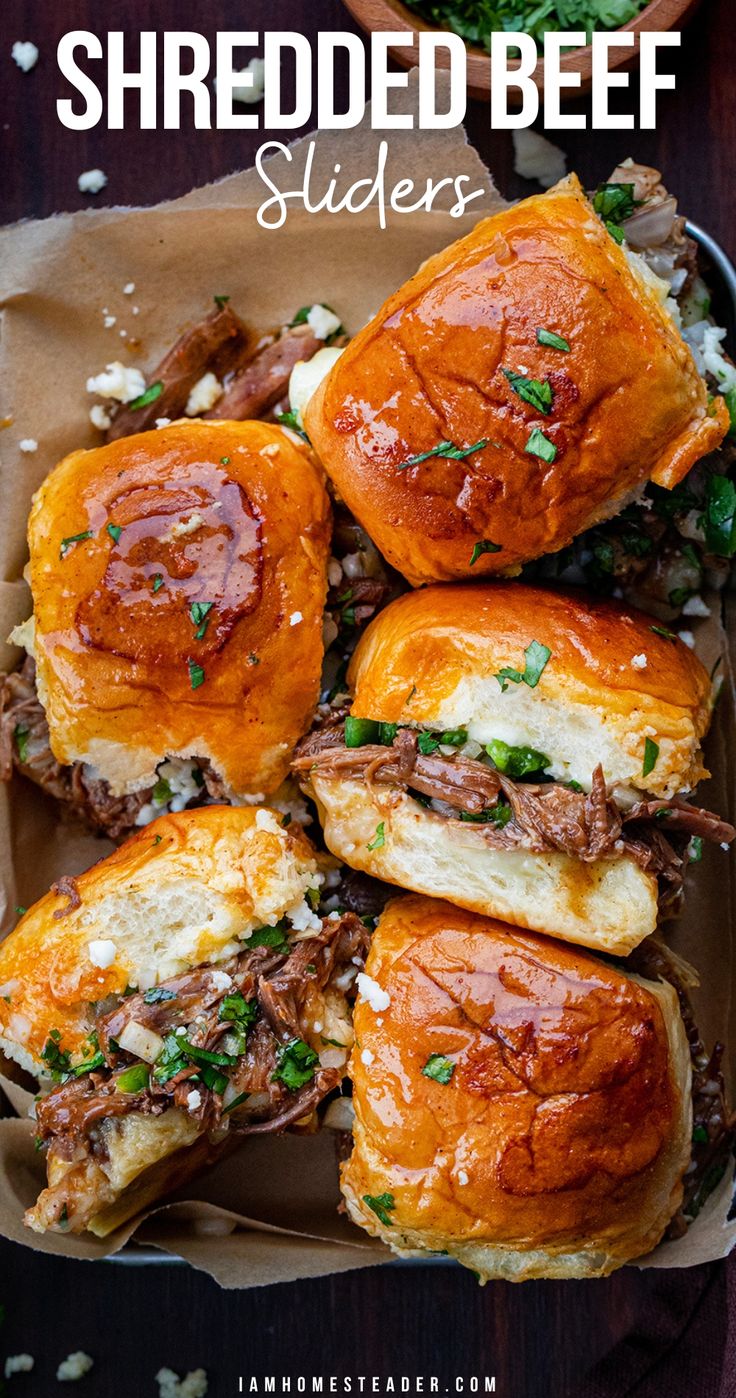 Sliders in a parchment lined tray, some turned on their side. Flank Steak Shredded Beef, Recipes Using Beef Roasts, Crockpot Shredded Meat Recipes, Crowd Meals Dinners, Bbq Shredded Beef Sandwiches, Hot Beef Sandwich Recipes, Chopped Beef Sliders, Beef And Blue Cheese Sliders, Shredded Beef Baked Potato