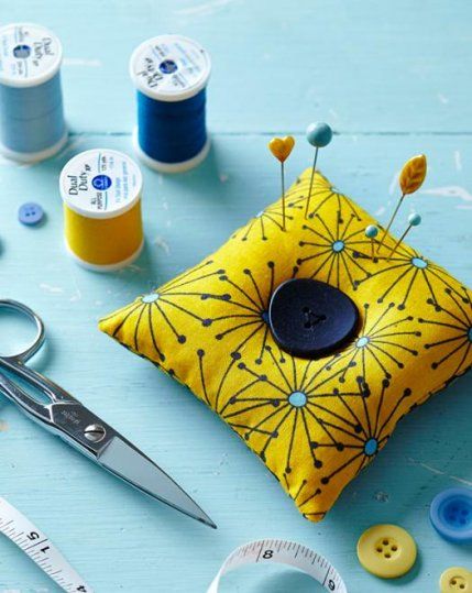 sewing supplies are laid out on a blue table