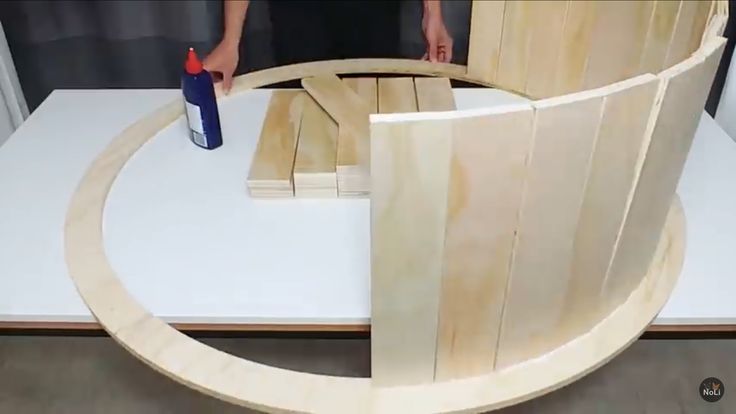 a person is making a wooden chair out of plywood