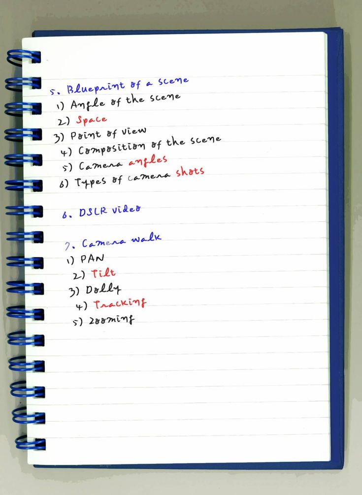 an open notebook with some writing on the page and numbers written in red, white and blue