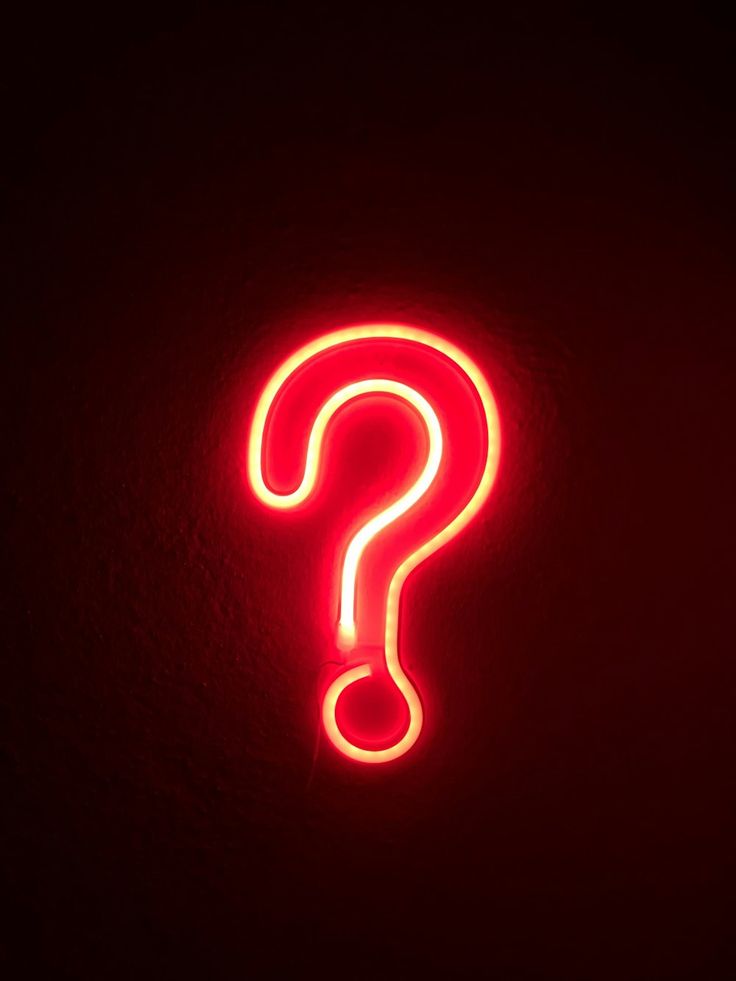 a red neon sign with a question mark on it