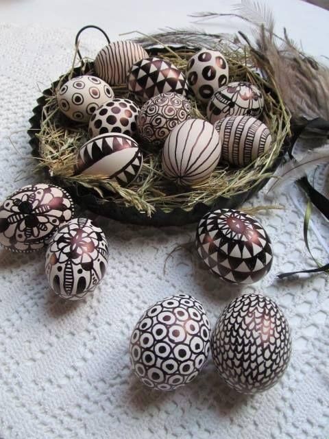 an arrangement of decorated eggs on a table